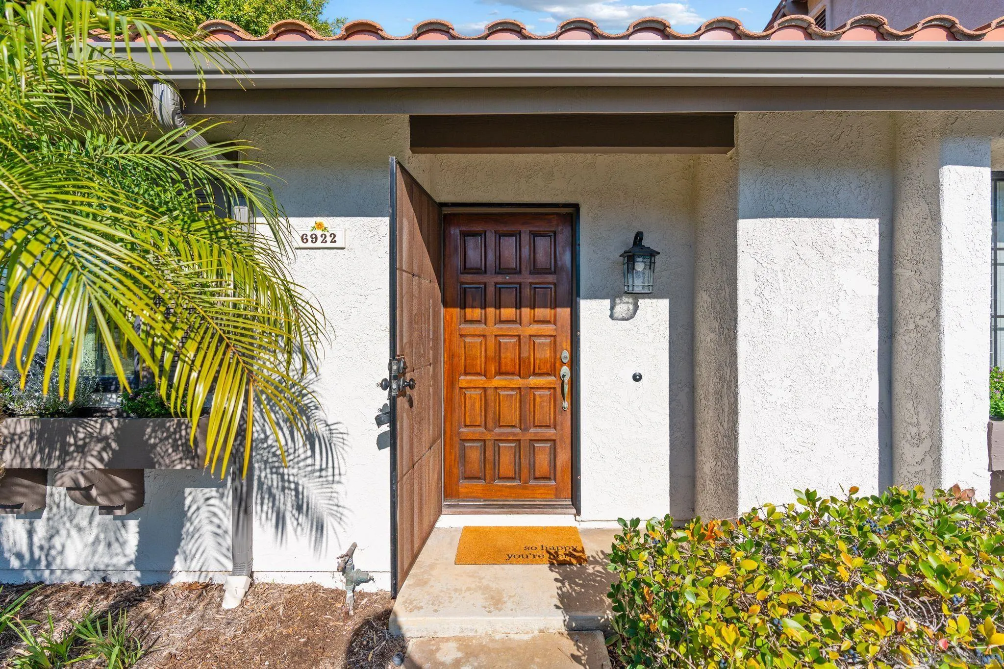 6922 Pear Tree Drive Carlsbad, CA 92011 - Photo 3 of 44 a front view of a house with a yard