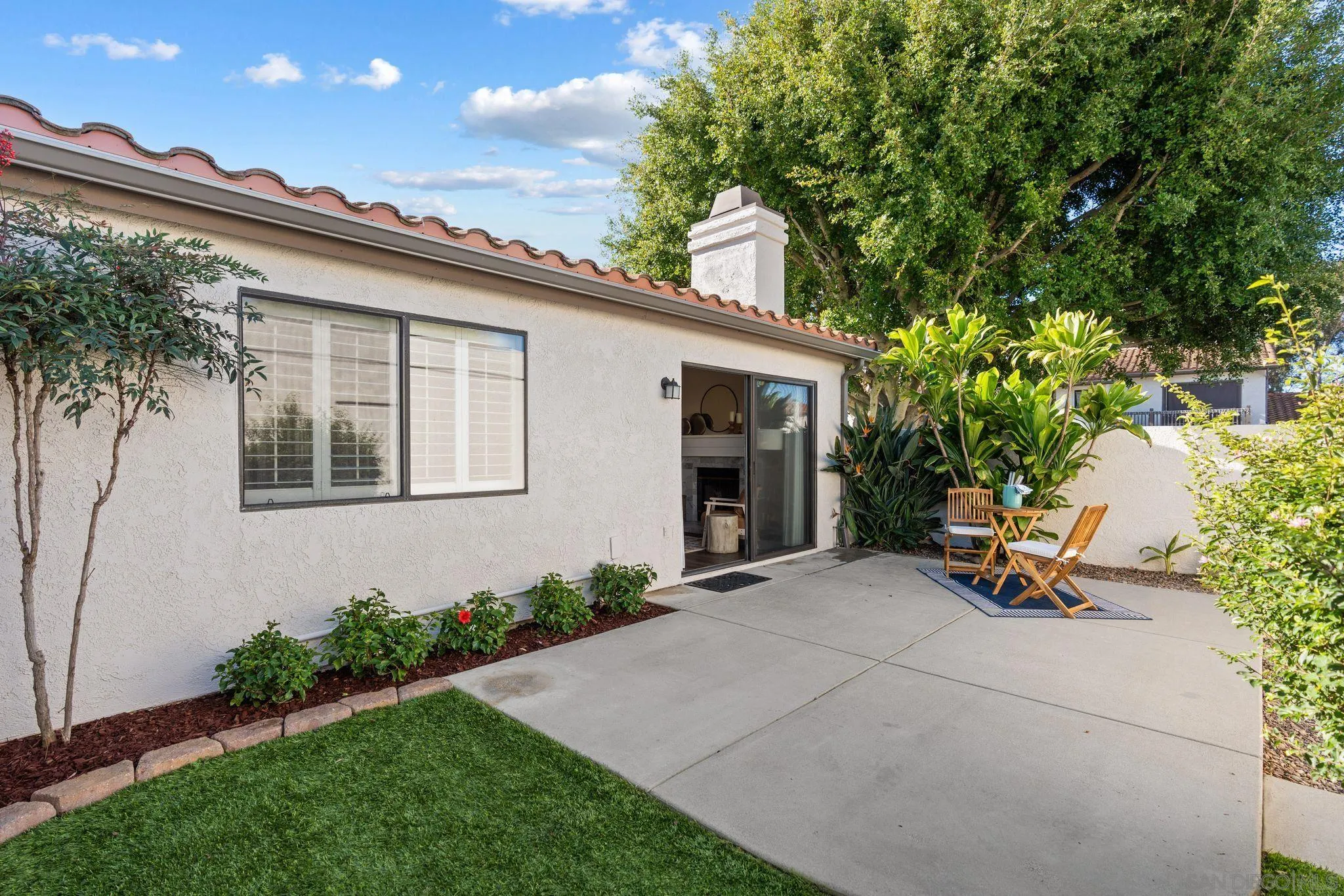 6922 Pear Tree Drive Carlsbad, CA 92011 - Photo 6 of 44 a backyard of a house with outdoor seating