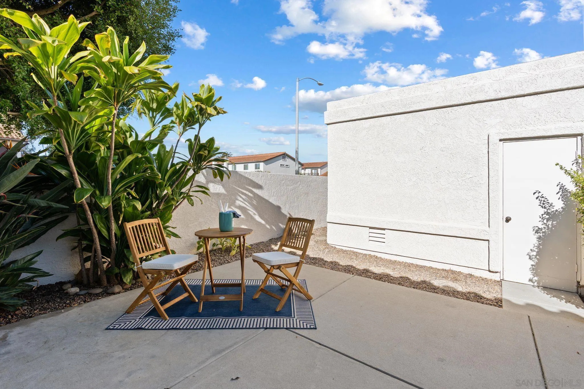 6922 Pear Tree Drive Carlsbad, CA 92011 - Photo 8 of 44 a view of a patio with table and chairs and potted plants