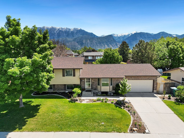 865 South 325 West Orem, UT 84058 - Photo 2 of 38 Split-level residence featuring a two-car garage, established landscaping, and a concrete driveway