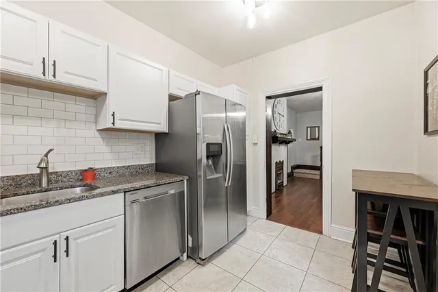 a kitchen with stainless steel appliances granite countertop a refrigerator and a sink