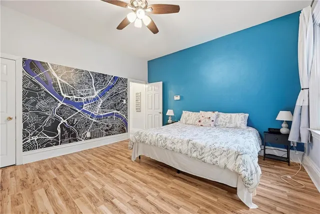 a bedroom with a bed and a wall painting