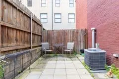 a view of a patio with table and chairs