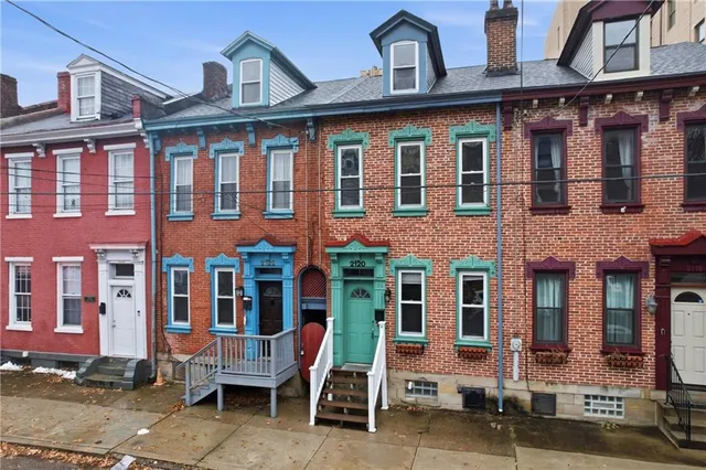 a front view of a building with a yard