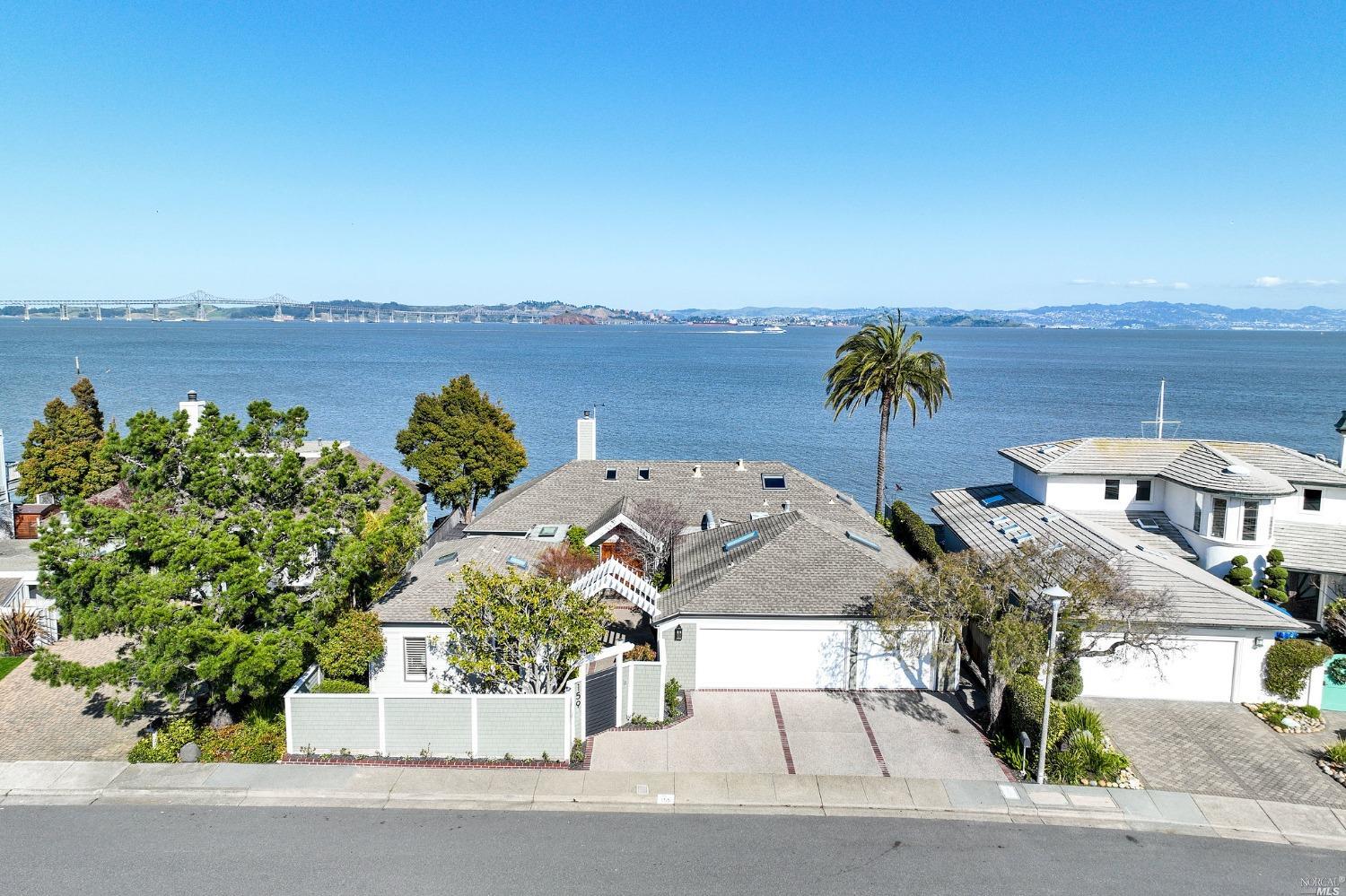 an aerial view of a house with a garden and lake view