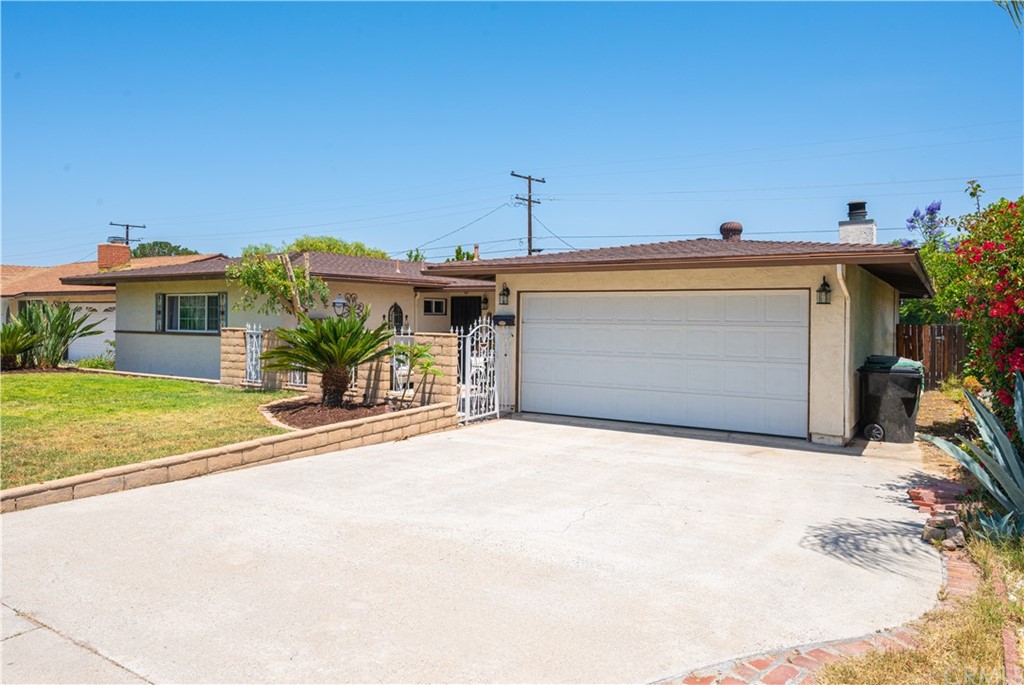 a front view of a house with a yard and a garage