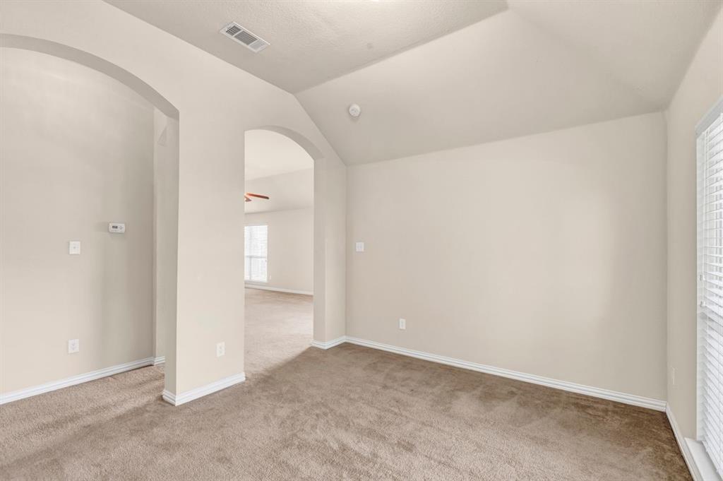 5316 Ridgeson Drive McKinney, TX 75071 - Photo 17 of 33 Carpeted room with vaulted ceiling and arched entryway
