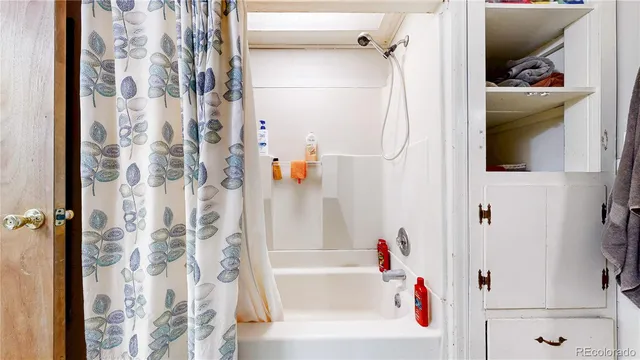 a bathroom with a bathtub and a shower