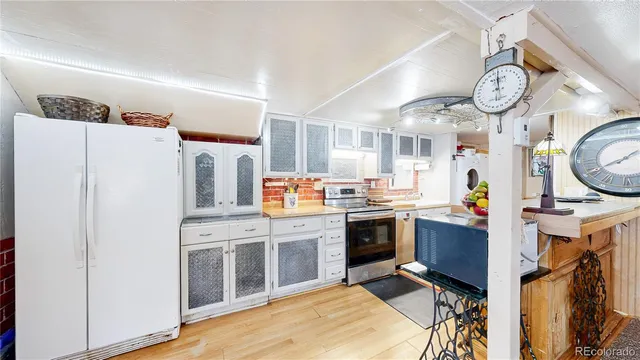a kitchen with stainless steel appliances granite countertop a stove and a refrigerator