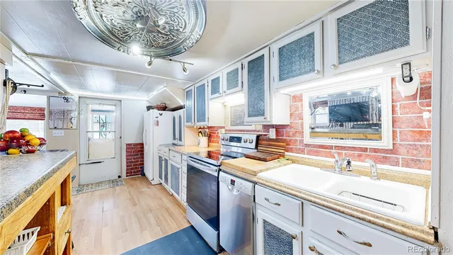 a kitchen with a sink stove and cabinets