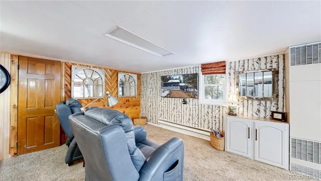 a bedroom with furniture and a large window