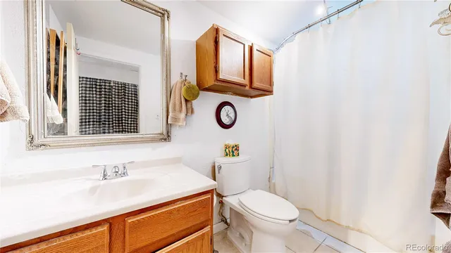 a bathroom with a sink toilet and mirror