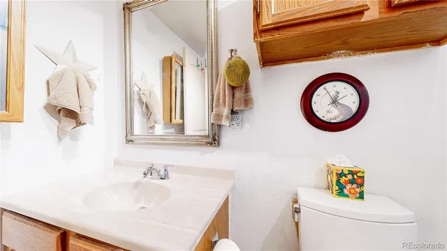 a bathroom with a sink a toilet and a mirror