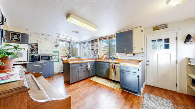 a kitchen with sink cabinets and wooden floor