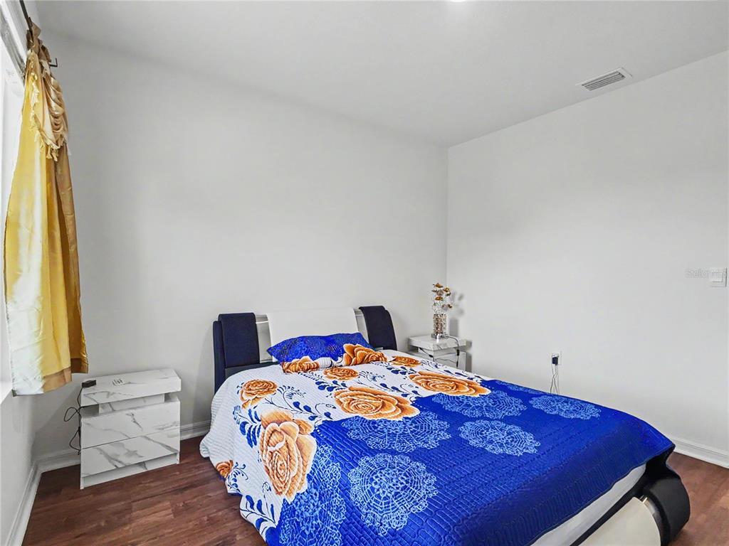 2085 Doe Run Drive Davenport, FL 33837 - Photo 34 of 44 a bedroom with a bed and a window