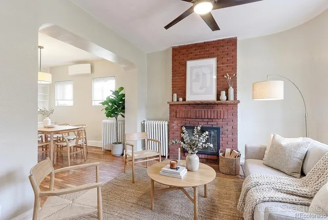 a living room with furniture and a fireplace