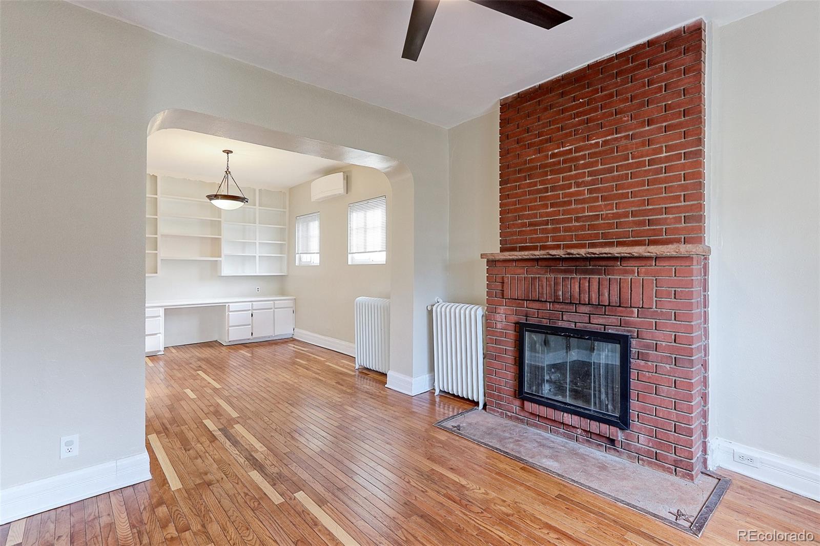 4574 Stuart Street Denver, CO 80212 - Photo 12 of 43 a view of a livingroom with wooden floor and a fireplace