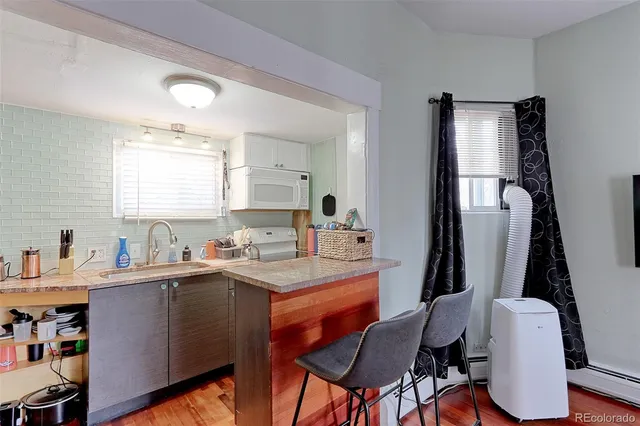 a view of a dining room with furniture and window