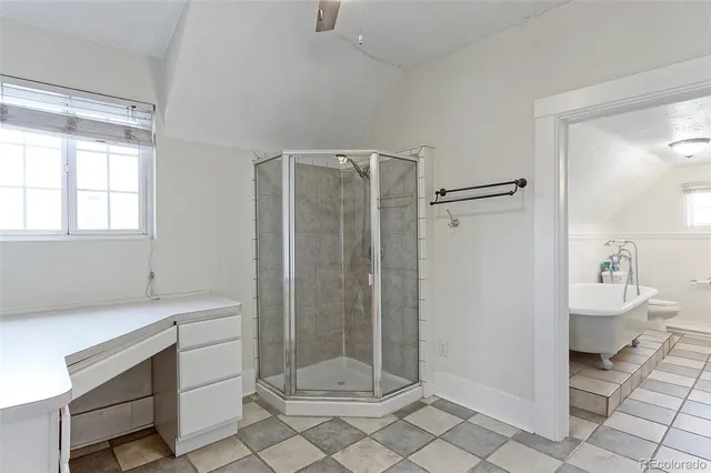 a bathroom with a shower sink and mirror