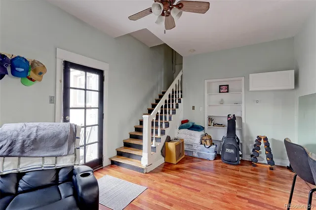 a view of a livingroom with furniture and hardwood floor