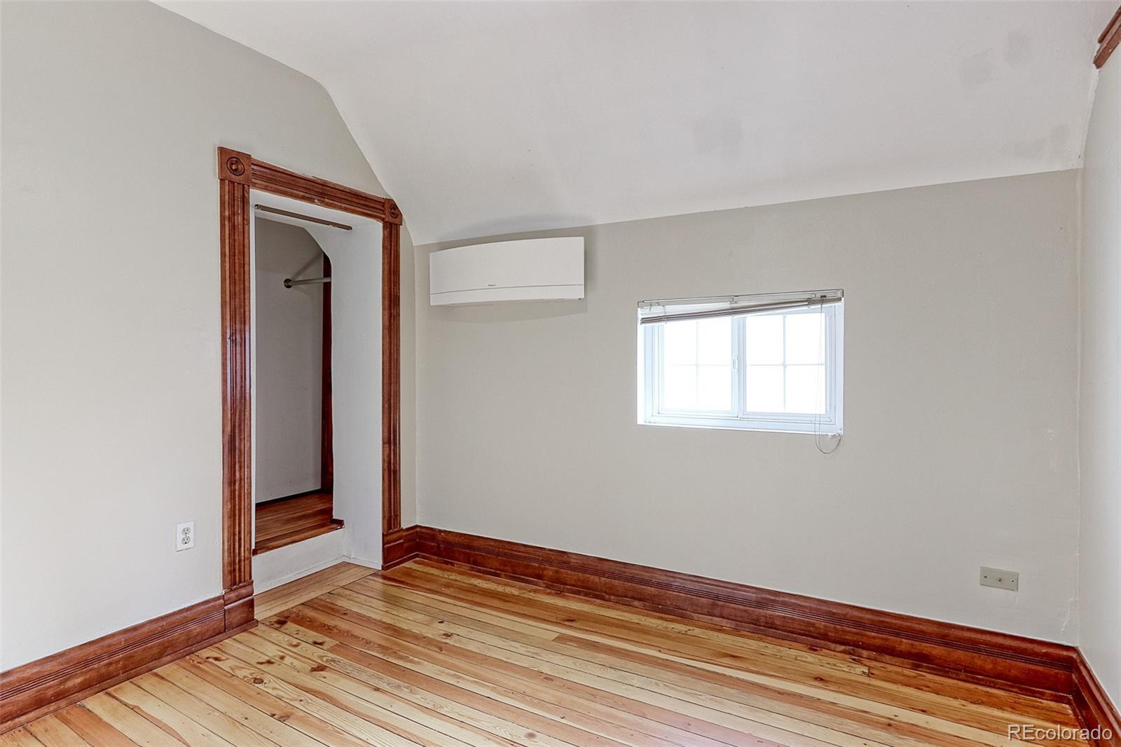 4574 Stuart Street Denver, CO 80212 - Photo 27 of 43 a view of an empty room with wooden floor and closet