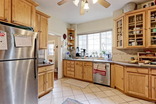 a kitchen with stainless steel appliances a refrigerator sink and cabinets