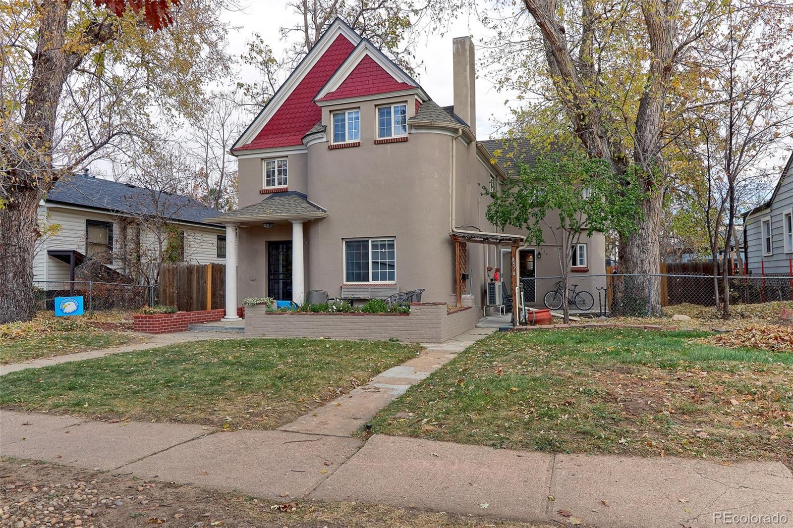 4574 Stuart Street Denver, CO 80212 - Photo 3 of 43 a front view of a house with a yard and garage