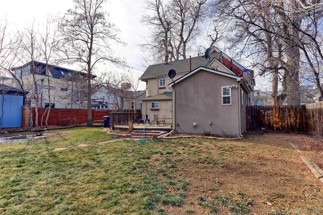 a kitchen with granite countertop a sink a stove and cabinets
