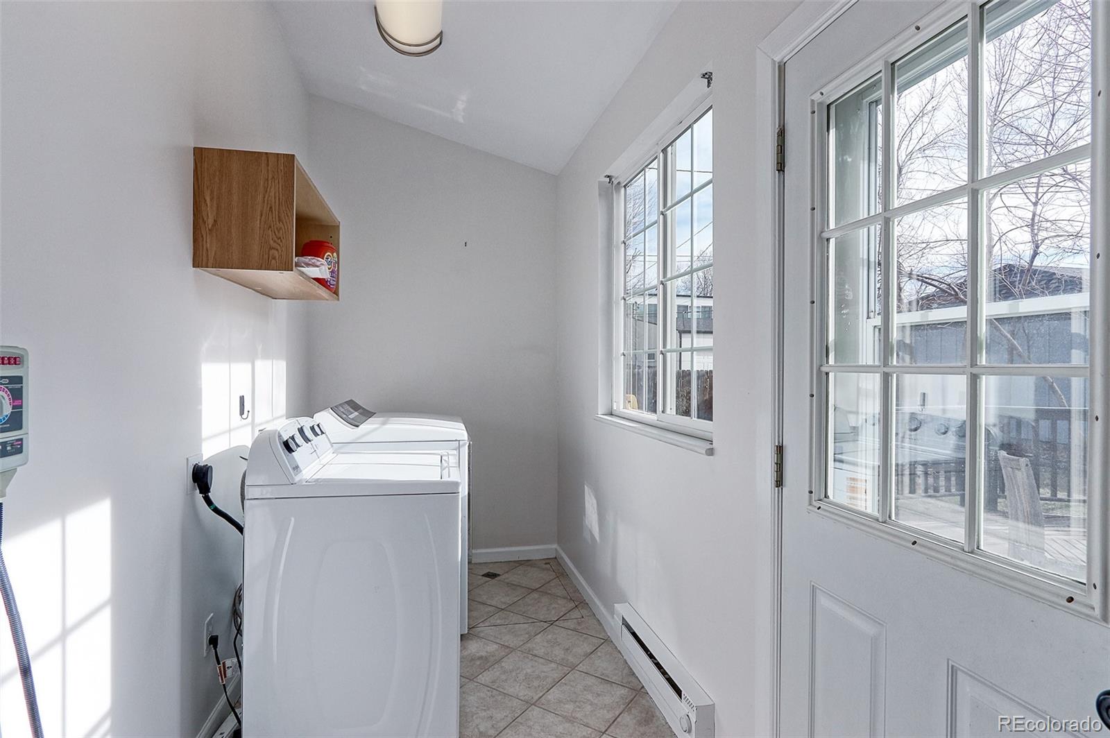 4574 Stuart Street Denver, CO 80212 - Photo 39 of 43 a bathroom with a sink mirror and window