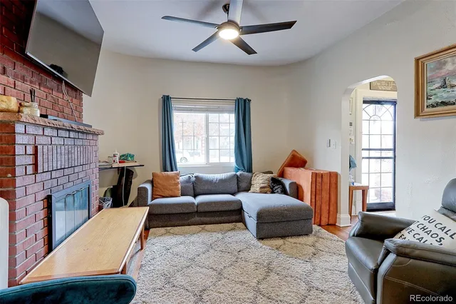 a living room with furniture and a fireplace