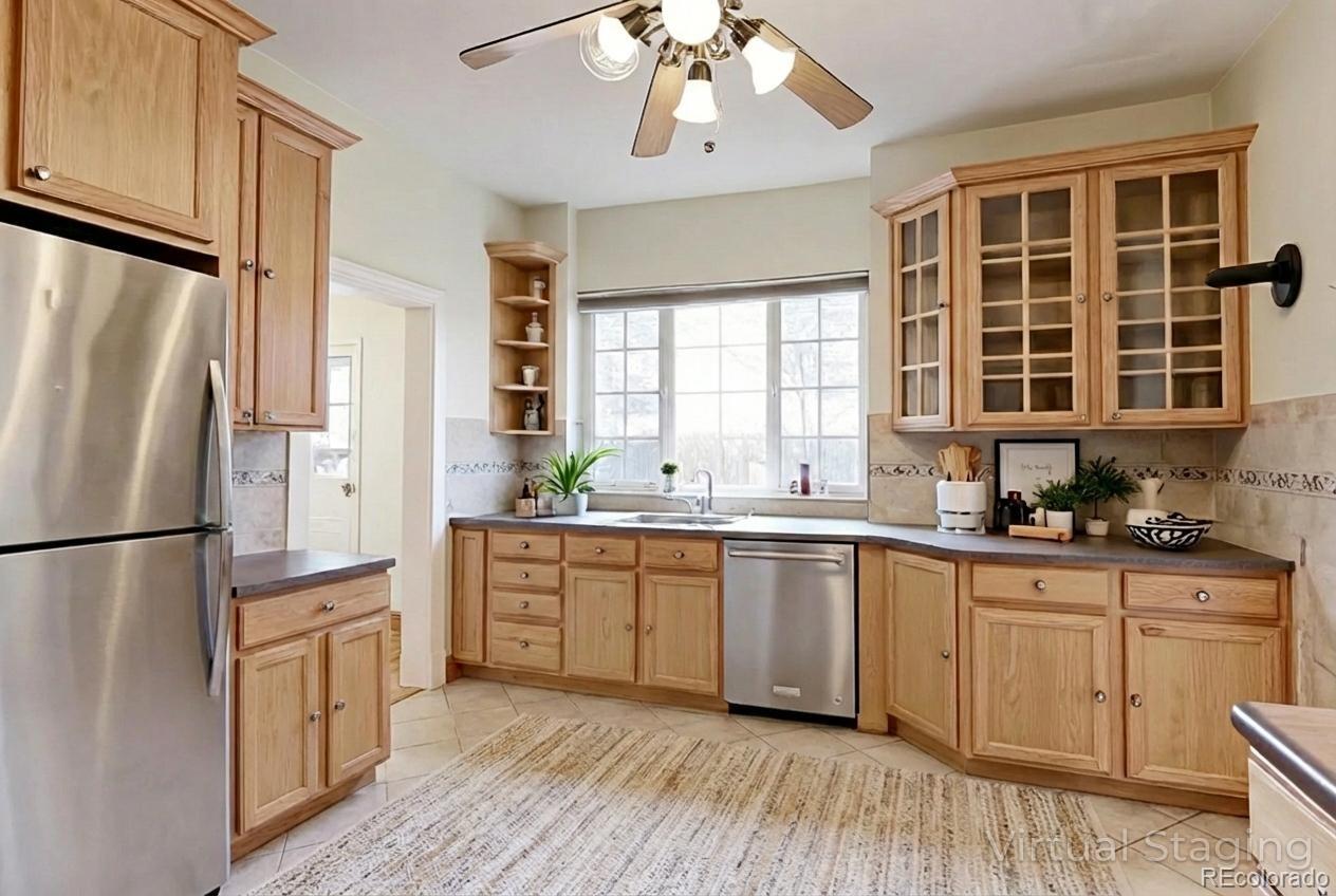 4574 Stuart Street Denver, CO 80212 - Photo 7 of 43 a kitchen with a refrigerator a sink cabinets and wooden floor