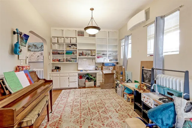 a living room with furniture and a chandelier