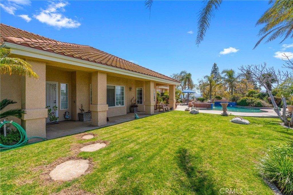 a view of a house with swimming pool and sitting area