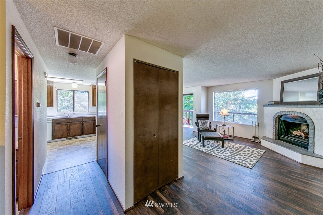 705 Sheridan Road Bremerton, WA 98310 - Photo 4 of 25 a view of a living room and a livingroom with furniture wooden floor a fireplace