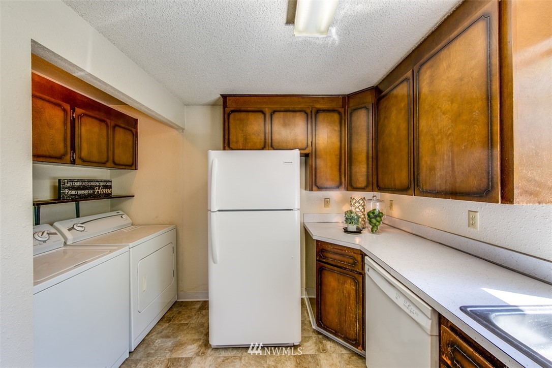 705 Sheridan Road Bremerton, WA 98310 - Photo 8 of 25 a kitchen with a refrigerator and a sink