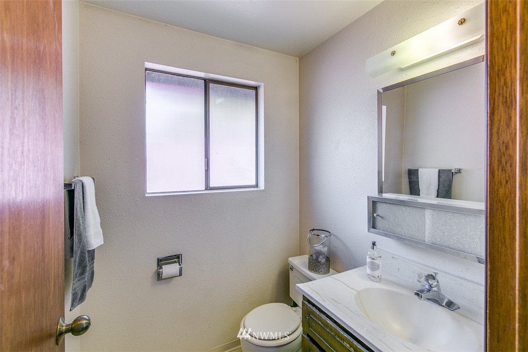 705 Sheridan Road Bremerton, WA 98310 - Photo 9 of 25 a bathroom with a sink toilet and mirror