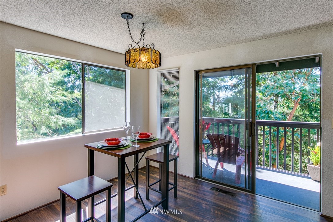 705 Sheridan Road Bremerton, WA 98310 - Photo 10 of 25 a dining room with furniture a chandelier and wooden floor