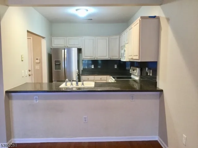 a kitchen with stainless steel appliances granite countertop a sink and cabinets