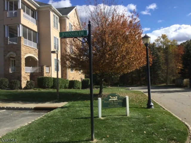 a view of a park with iron fence