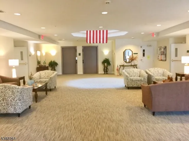 a living room with furniture and a large mirror