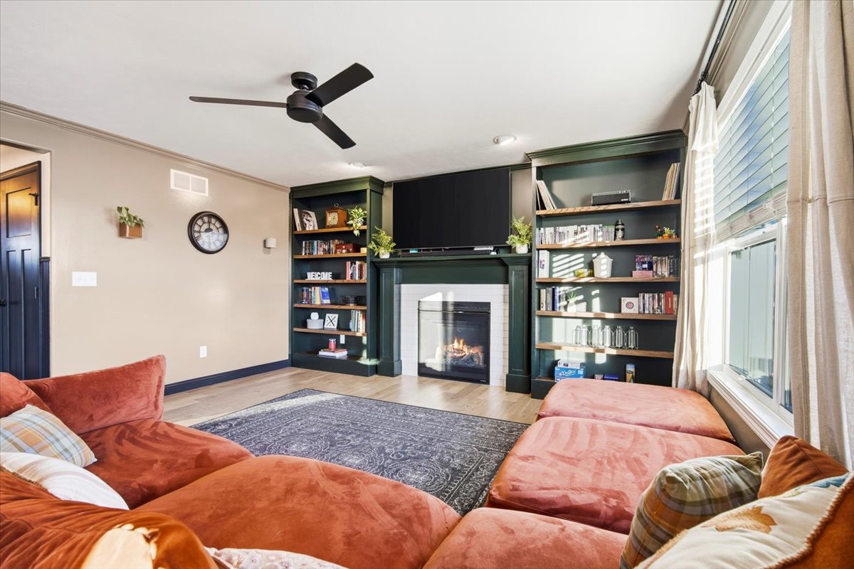 2625 Shale Road Normal, IL 61761 - Photo 19 of 60 a living room with furniture a fireplace and a flat screen tv