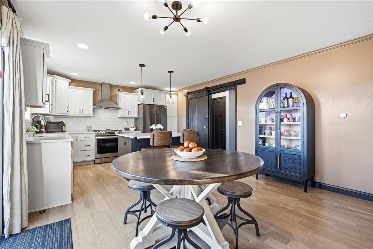 2625 Shale Road Normal, IL 61761 - Photo 25 of 60 a kitchen with stainless steel appliances granite countertop a dining table and chairs with wooden floor
