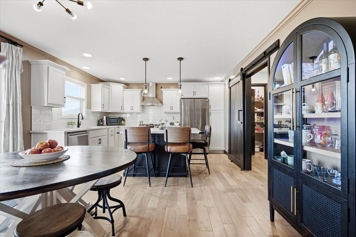 2625 Shale Road Normal, IL 61761 - Photo 26 of 60 a kitchen with stainless steel appliances a dining table chairs and a refrigerator