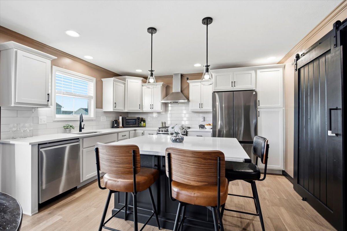 2625 Shale Road Normal, IL 61761 - Photo 27 of 60 a kitchen with stainless steel appliances a dining table chairs and a refrigerator