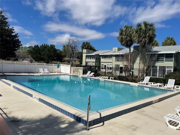 a view of a swimming pool with a lounge chairs