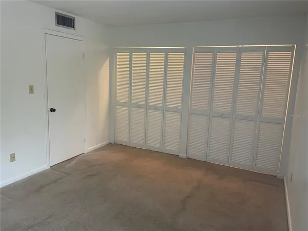 a view of an empty room with windows