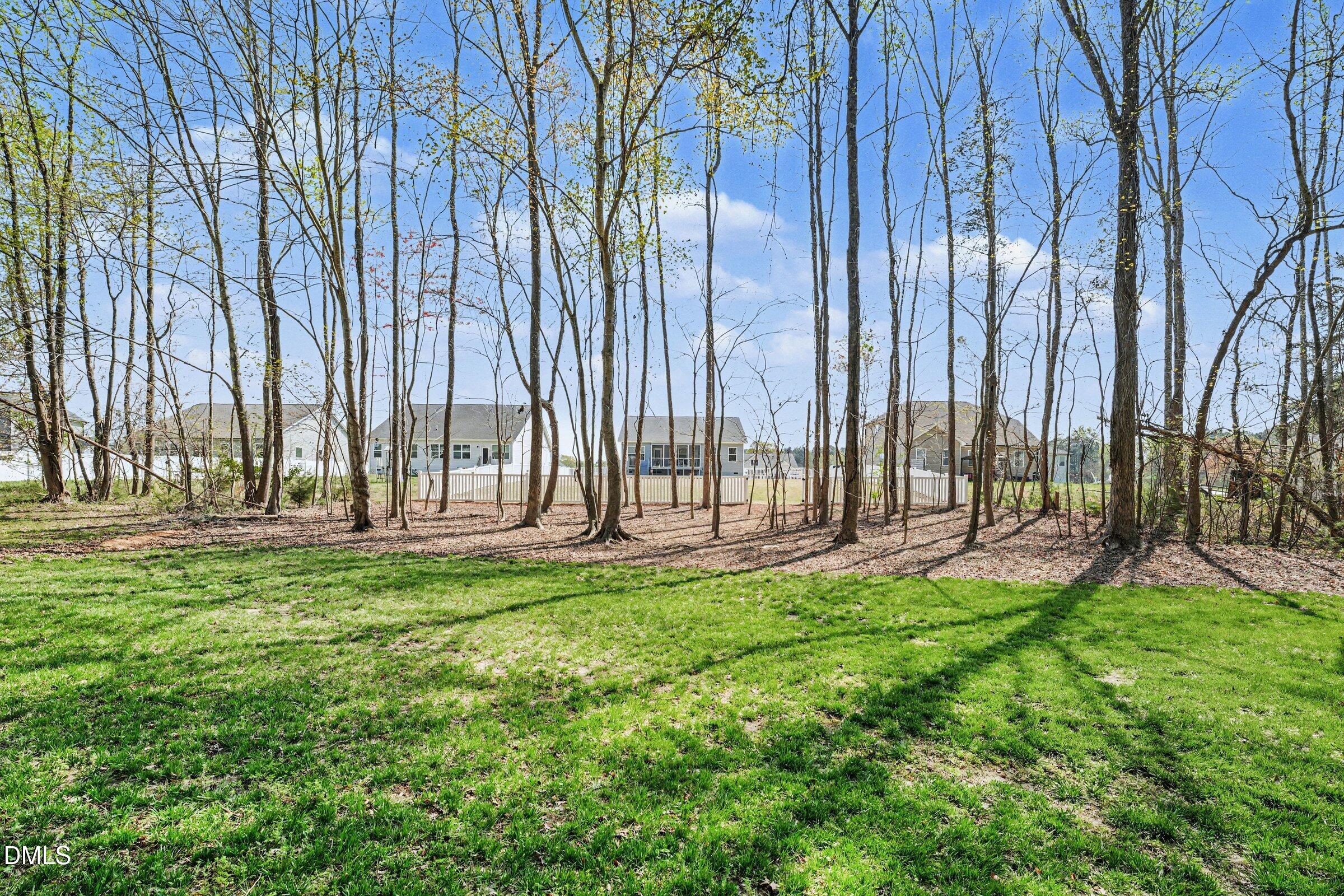 130 Aylebury Ridge Zebulon, NC 27597 - Photo 31 of 41 a view of yard with a bench and trees