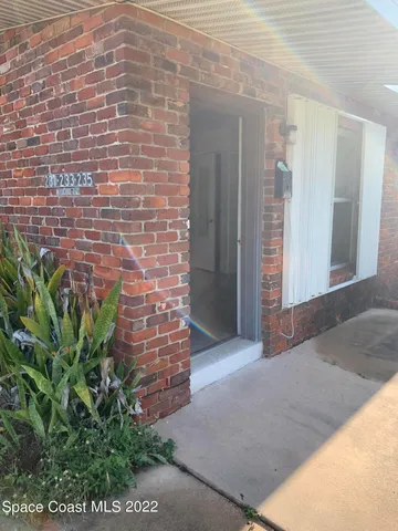 a view of front door of house with yard