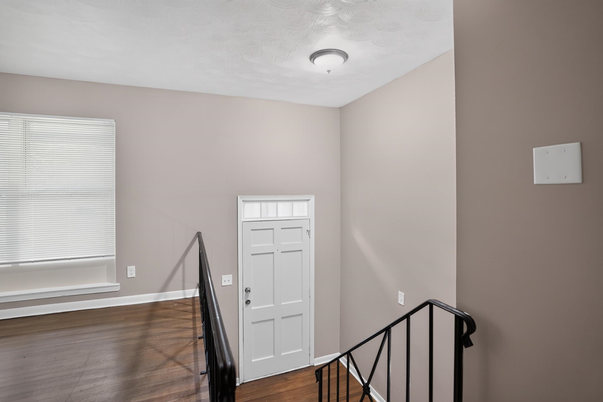 3391 South Perkins Road Memphis, TN 38118 - Photo 11 of 16 Interior space featuring wood-finish flooring, a paneled door with transom window, and a modern semi-flush mount ceiling light