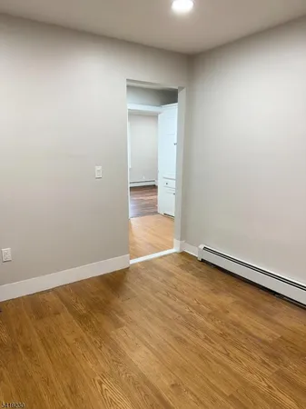 a view of an empty room and wooden floor